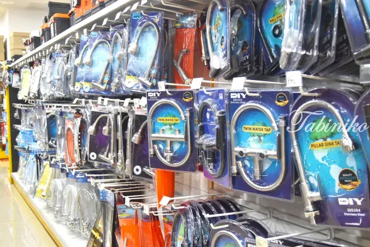 Shelves of MR.DIY stainless steel kitchen faucets and taps displayed in a store.