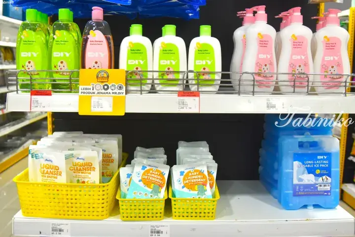 Shelves stocked with baby care products and cleaning supplies at a Mr. DIY store in Malaysia.