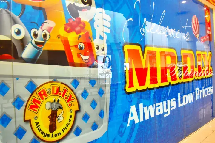 MR.DIY storefront window featuring cartoon product mascots and the slogan Always Low Prices at The Mines shopping mall.