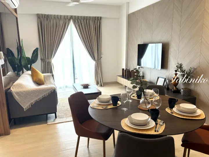 Modern dining table set for four in a bright living room with a grey sofa and large window curtains.