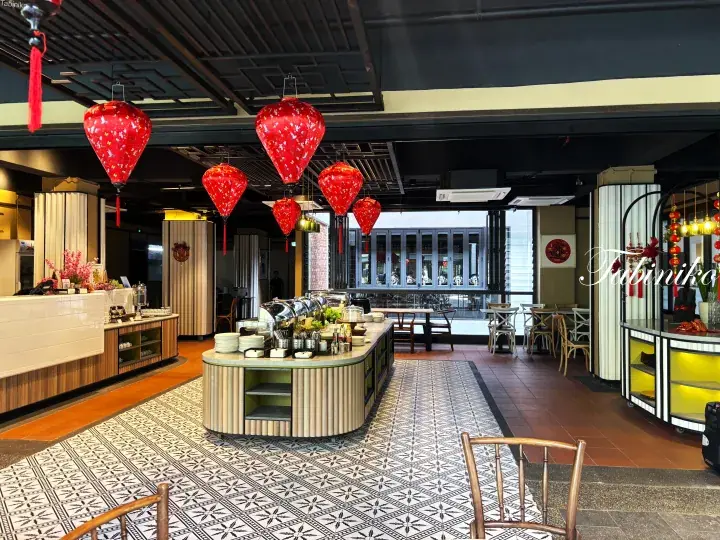 Restaurant interior with red lanterns, buffet station, and patterned tile floor.
