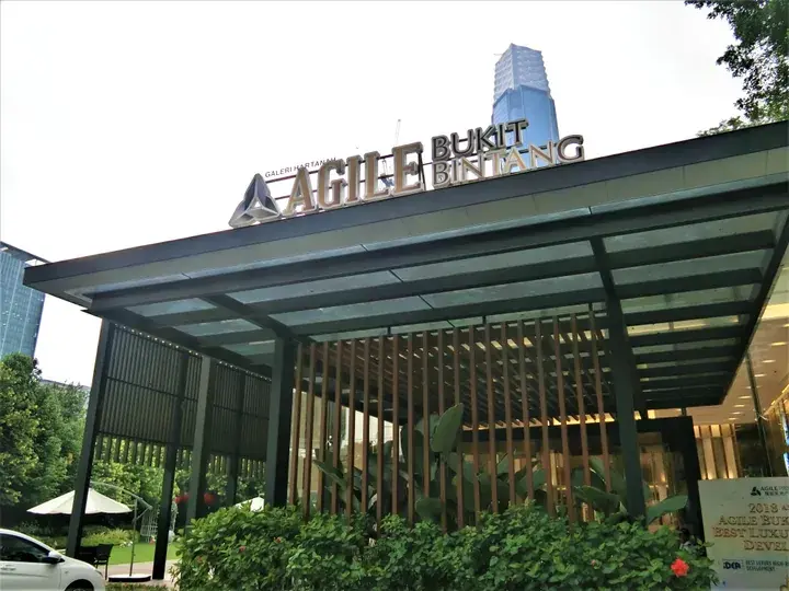 Modern entrance canopy of Agale Bukit Bintang with wooden slats and greenery, Kuala Lumpur.