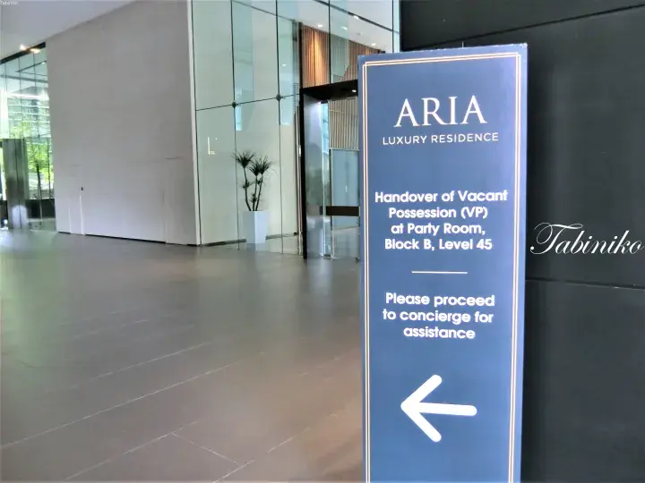 Blue ARIA Luxury Residence sign directing visitors to the Party Room on Level 45 for vacant possession handover.
