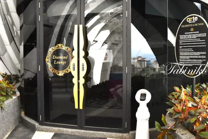 Entrance to the Arte Hotel Diamond Lounge in Kuala Lumpur featuring glass doors and elegant signage.