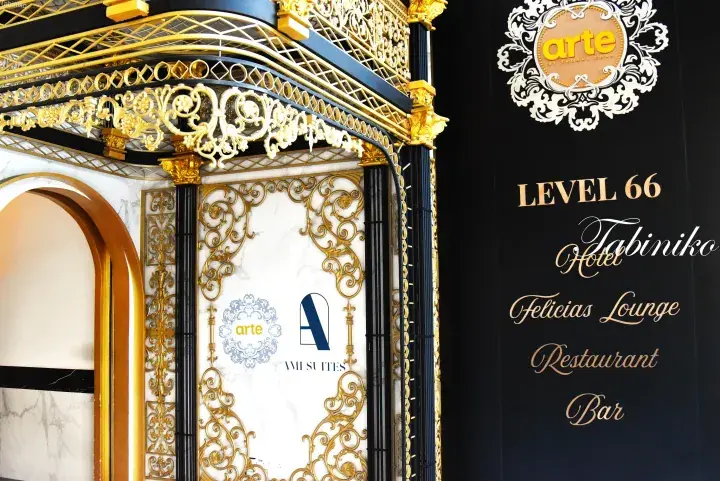 Ornate gold and black elevator entrance at Tabiniko Hotel Level 66, featuring signage for Arte, Felicias Lounge, Restaurant, and Bar.