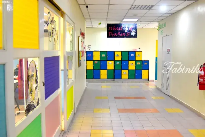 Colorful hallway with lockers and classroom doors at a school.