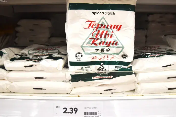 Stacks of Tapioca Starch bags on a supermarket shelf with a price tag of RM 2.39.