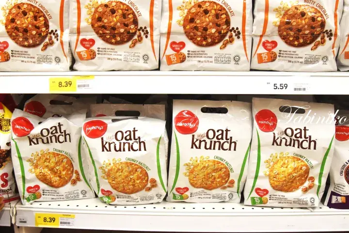 Shelves stocked with Manong’s Oat Krunch cereal and chocolate cookies at a Malaysian supermarket.