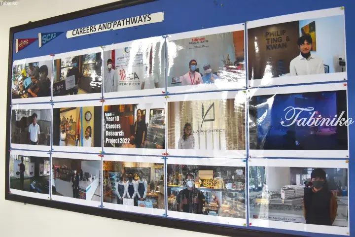 A display board showcasing career pathways with photos of students and businesses like Philip Ting & Kwan and Tabiniko.