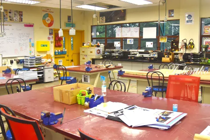 Interior of a well-equipped design and technology classroom with student workstations and tools.