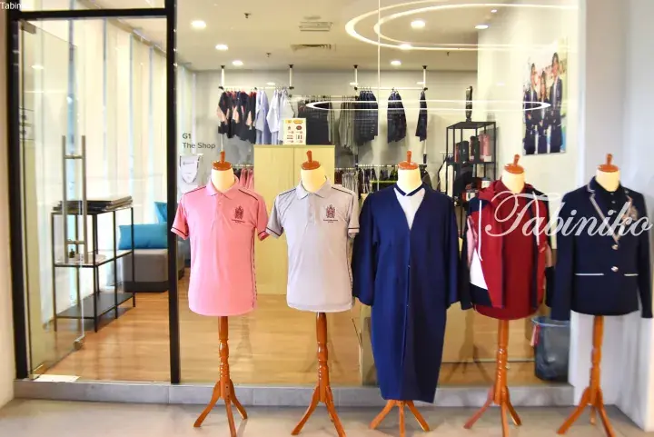 Mannequins displaying Charterhouse school uniforms including polo shirts and blazers at The Shop.