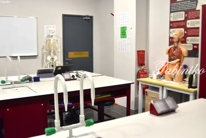 Science classroom with lab tables, skeleton model, and anatomical torso in Malaysia