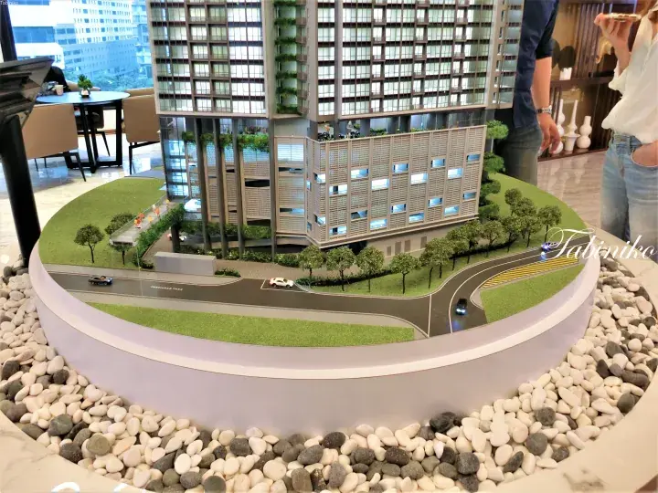 Architectural model of a modern high-rise building with greenery and surrounding roads at Persiaran TRX2.