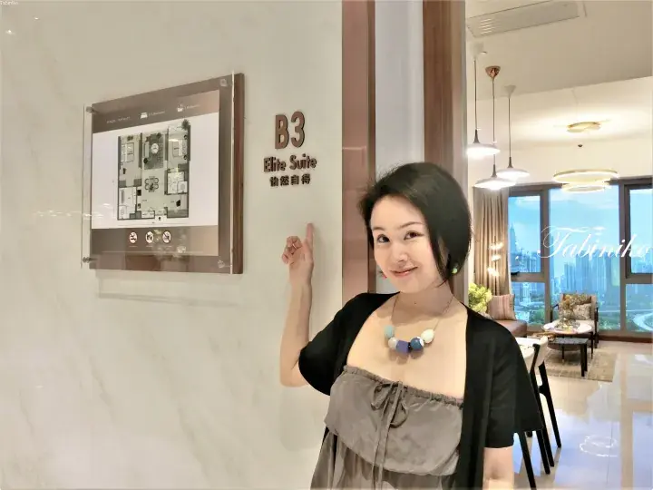 Woman pointing at B3 Elite Suite sign and floor plan in a modern Kuala Lumpur serviced residence.