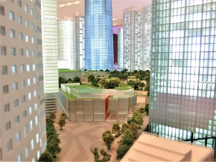 Architectural model of a modern urban development featuring high-rise towers and landscaped green spaces.