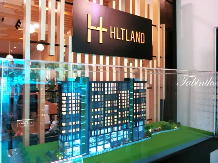 Architectural model of a modern high-rise building at the HLTLAND sales gallery.