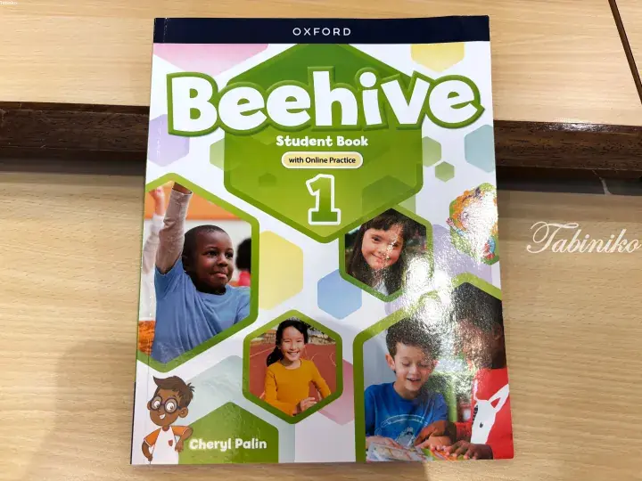 Oxford Beehive Student Book 1 by Cheryl Palin, an English learning textbook featuring children in hexagonal frames.