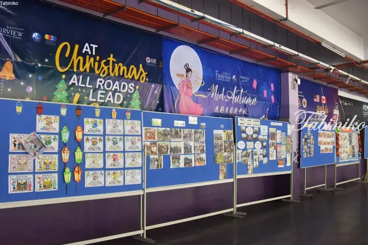 Fairview International School’s cultural exhibition hall featuring banners for Christmas, Mid-Autumn Festival, and Aidilfitri alongside student artwork.