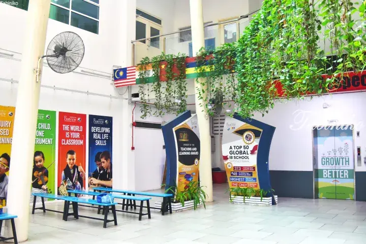 Fairview International School hallway with IB awards, motivational posters, and hanging plants.