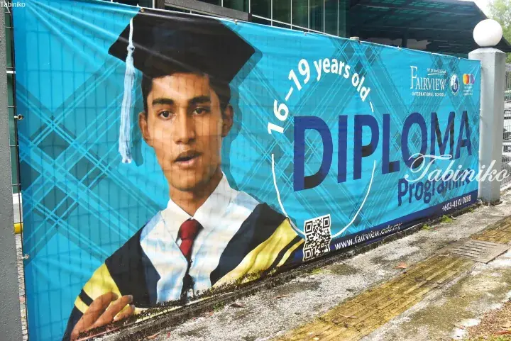 Fairview International School banner advertising the Diploma Programme for ages 16-19, featuring a graduate in cap and gown.