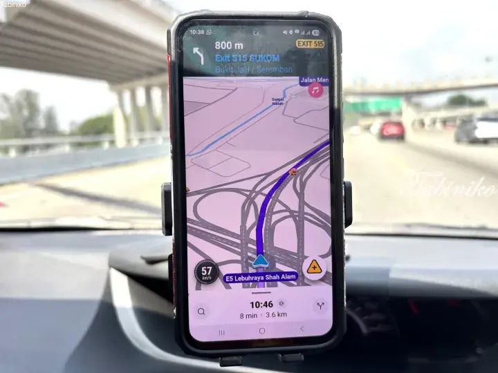 Smartphone displaying navigation to Exit 515 SUKOM on E5 Shah Alam Highway in Malaysia.