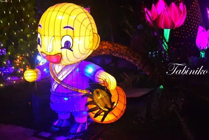 Glowing lantern of a cartoon monk character at a night festival, holding a lantern and a basket.