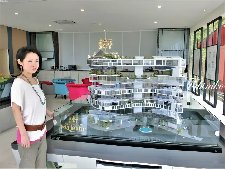 Woman standing beside a detailed architectural model of Grand Ion Majestic at Genting Highlands.