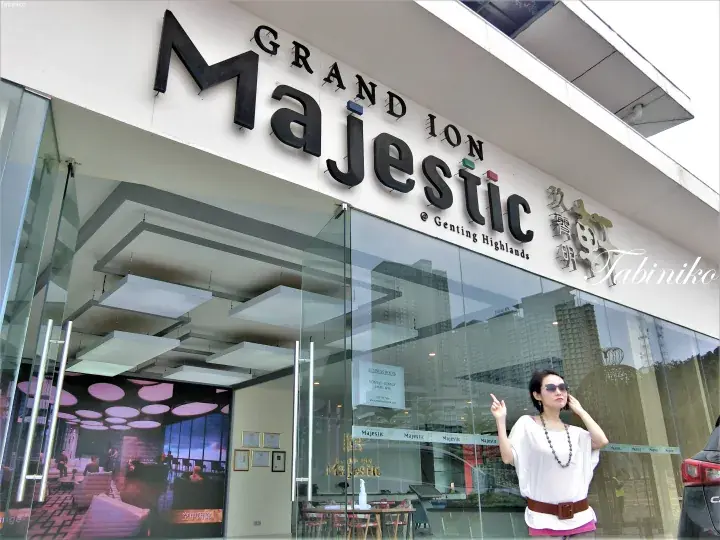 Woman posing outside the entrance of Grand Ion Majestic hotel in Genting Highlands, Malaysia.