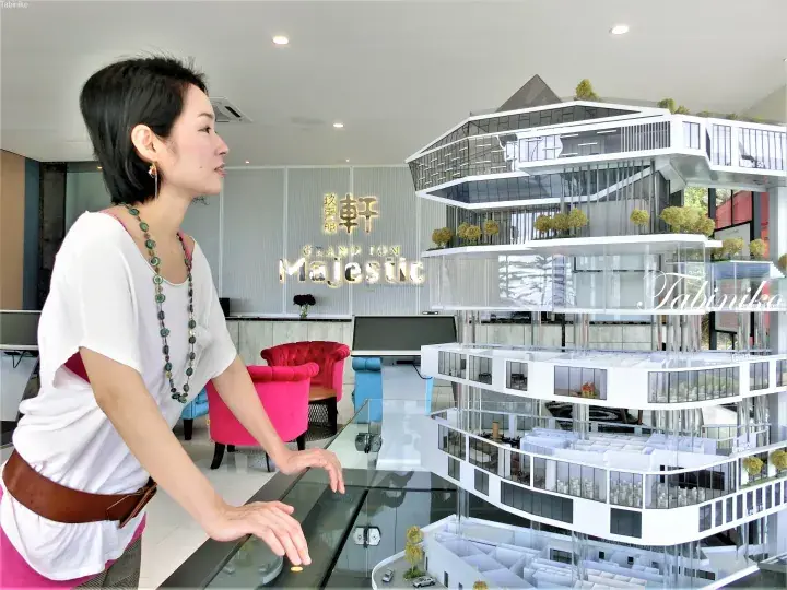 Woman viewing the architectural model of Grand Ion Majestic, a luxury residential development in Malaysia.