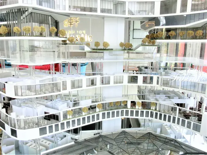 Architectural model of a modern high-rise building showcasing multiple levels, glass facades, and interior amenities.