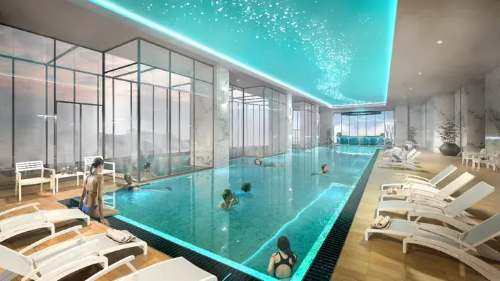Luxurious indoor infinity pool with starry ceiling and panoramic mountain views in a Malaysian resort.