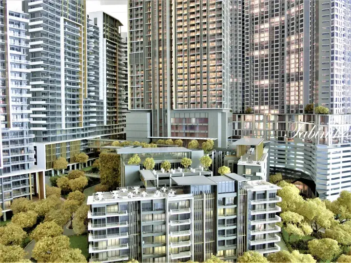 Architectural model of a modern high-rise residential complex with lush greenery and multi-level amenities.
