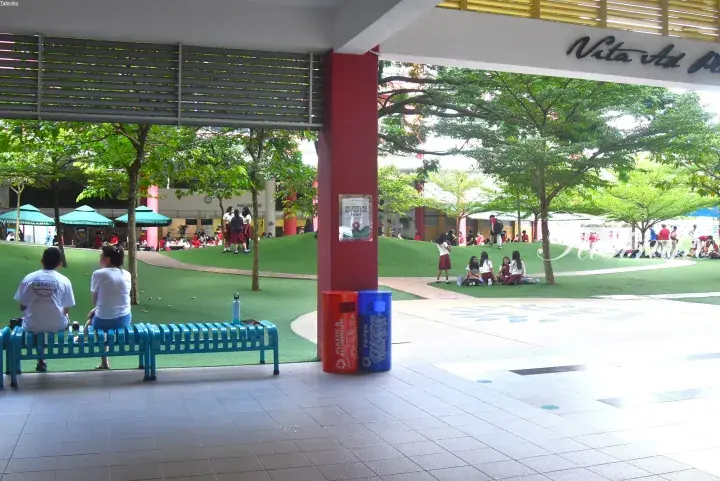 Students relax on a green lawn at the campus of a Malaysian international school.