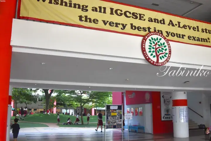 HELP International School campus entrance with a banner wishing IGCSE and A-Level students well.