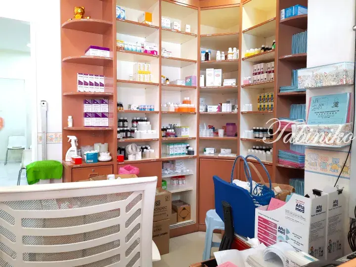 Interior of a wellness clinic showing wooden shelves stocked with skincare products and medical supplies.