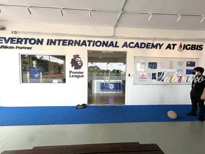 Entrance to Everton International Academy at IGBIS featuring Premier League logo and blue carpet.