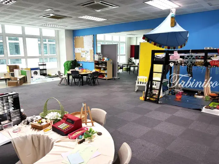 Colorful play area in a Malaysia property featuring a carousel tent, bunk bed, and toy cash register.