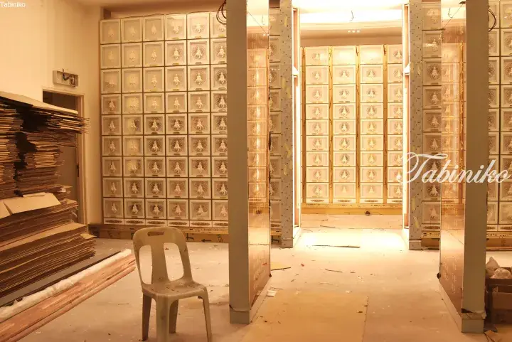 Interior of a Chinese medicine shop under renovation with stacked drawers and cardboard boxes.