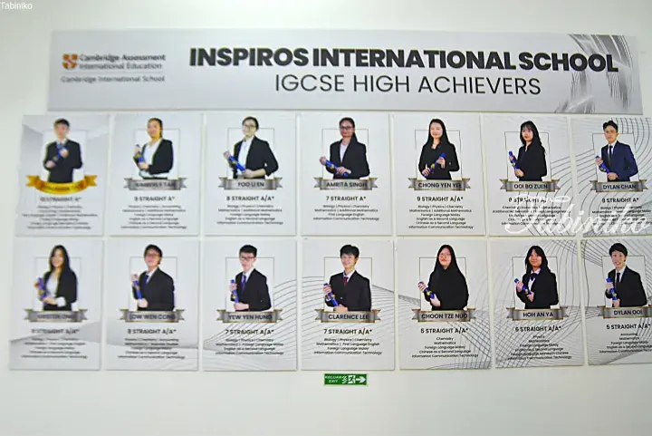 Inspiros International School IGCSE High Achievers display board featuring student photos and academic achievements.
