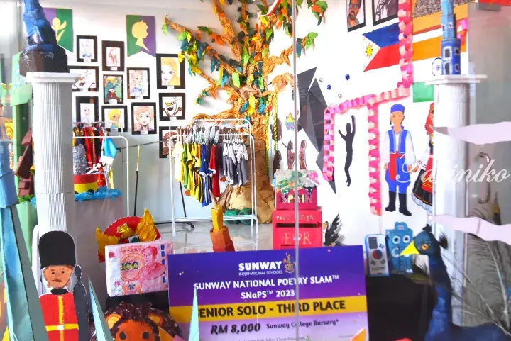 Sunway National Poetry Slam 2023 award certificate displayed among cultural decorations and student artwork.