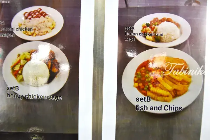 Menu display showing set meals including macaroni chicken, honey chicken with vegetables, lemon chicken, and fish and chips.