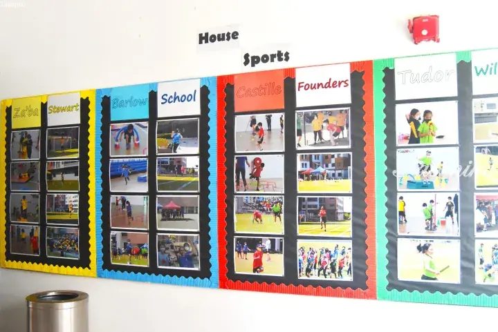 School bulletin board displaying house sports activities for Barlow, Castille, Founders, Stewart, and Tudor houses.