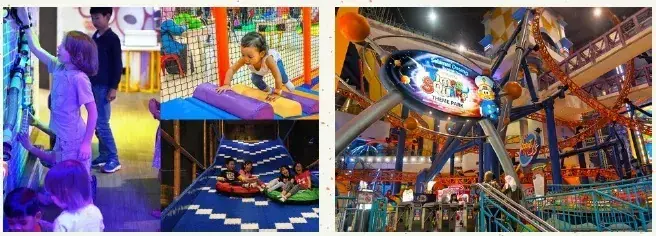 Children enjoying indoor playground activities including climbing walls and slides at a family entertainment center.