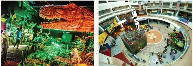 Split view showing a dinosaur exhibit with a large T-Rex head and a multi-level indoor playground with climbing structures.