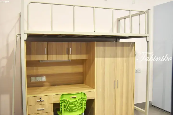 Modern student dormitory loft bed with integrated desk, wardrobe, and overhead cabinets.
