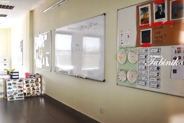 Classroom whiteboard with French lesson notes and Monet art display for Year 6 students.
