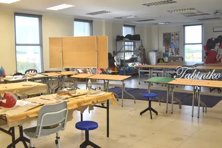 Bright art classroom with wooden tables, chairs, and a Mickey Mouse cutout in a Malaysia property.