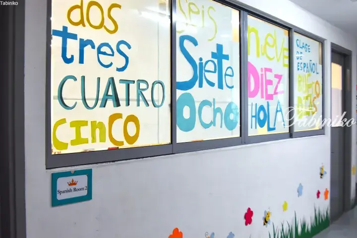 Colorful Spanish numbers and words on classroom windows with a sign reading Spanish Room 2.