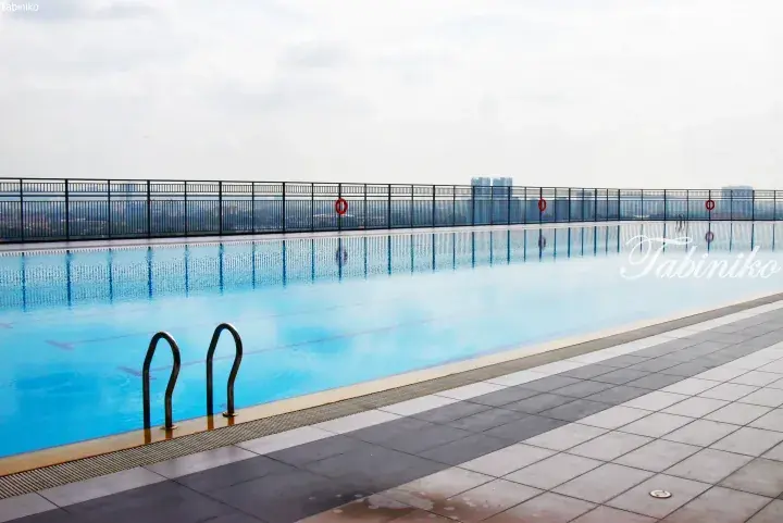 Rooftop infinity pool with city skyline view at a Malaysia property