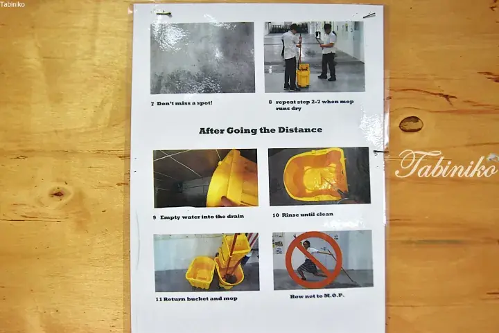 Instructional poster showing students mopping floors and cleaning yellow buckets with captions like ‘Don’t miss a spot!’ and ‘How not to M.O.P.’